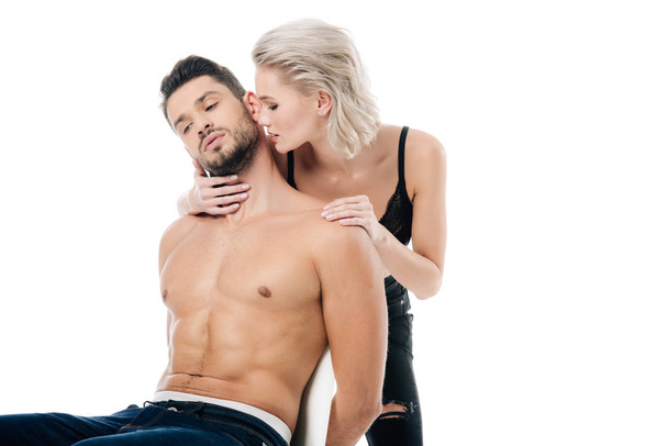 sexy girlfriend touching handsome shirtless boyfriend isolated on white - Fotó, kép