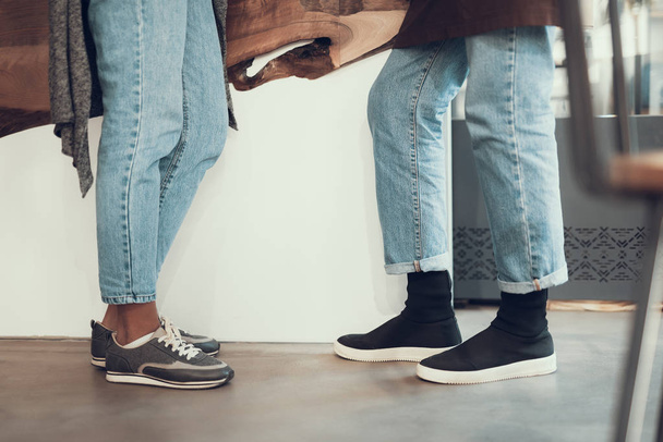 Cropped photo of two pairs of legs in blue jeans - Fotografie, Obrázek
