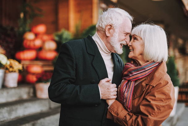 Happy senior couple touching noses on the street - Fotoğraf, Görsel