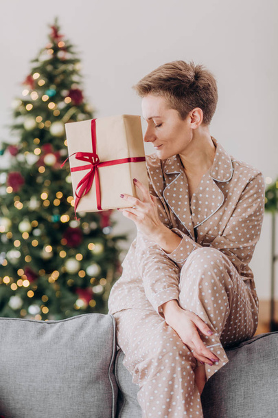 girl in pajamas celebration christmas a glass of champagne with gift boxes decor christmas tree - Foto, immagini