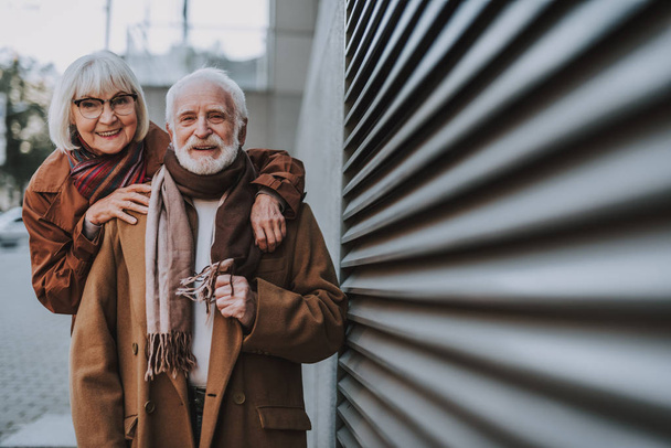 Happy elderly couple standing on the street - Фото, изображение