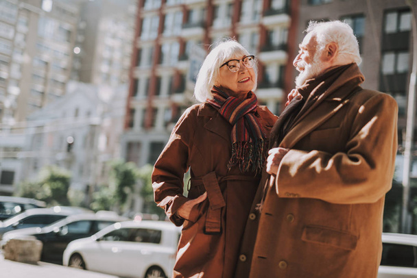 Beautiful senior couple looking at each other and smiling - Фото, изображение