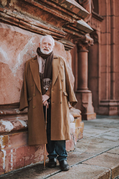 Stylish old man with walking stick posing on the street - Zdjęcie, obraz