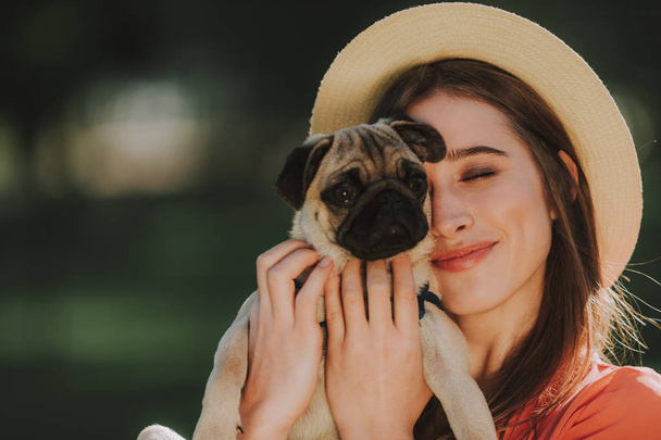 Young dogs owner is gently hugging her pet - Foto, immagini