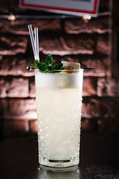 close up view of refreshing alcohol cocktail with mint on black tabletop - Фото, зображення