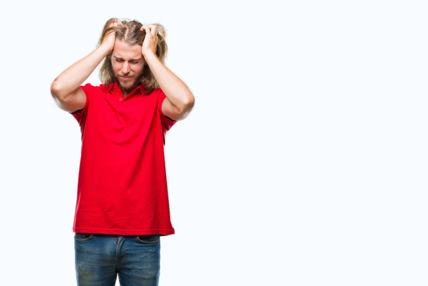 Young handsome man with long hair over isolated background suffering from headache desperate and stressed because pain and migraine. Hands on head. - Photo, Image