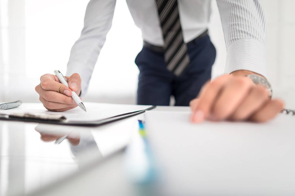 Business man signing contract document on office desk - Fotó, kép