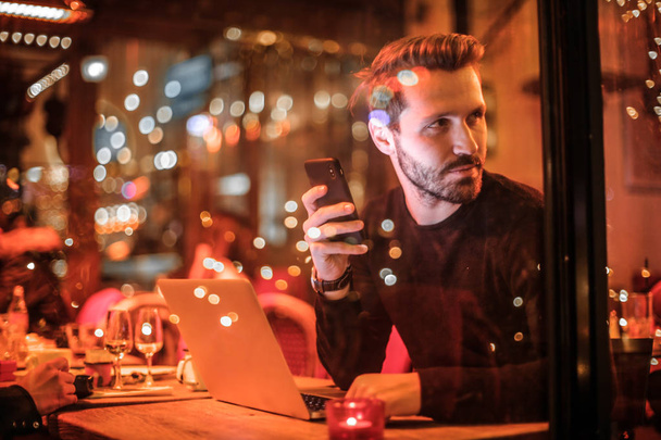 handsome man with laptop and smartphone portrait - 写真・画像