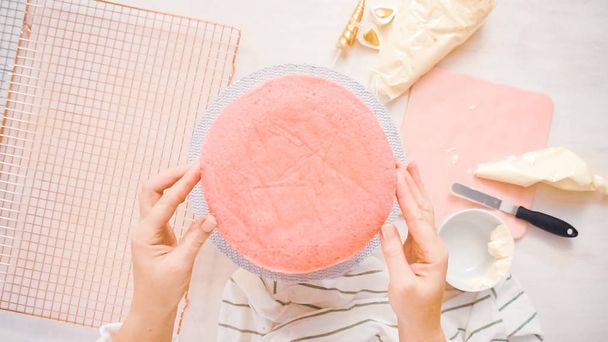 Flat lay. Assembling pink and purple cake layer to make unicorn cake for little girl's birthday party. - Photo, Image