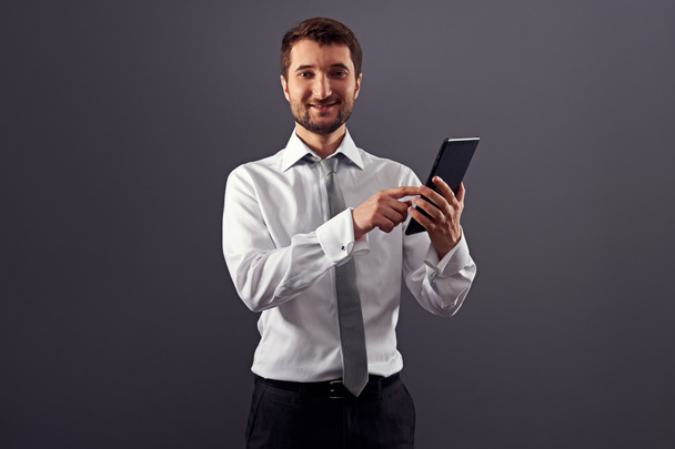 smiley businessman pointing at tablet pc - 写真・画像