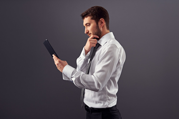 thoughtful businessman with tablet pc - Photo, Image