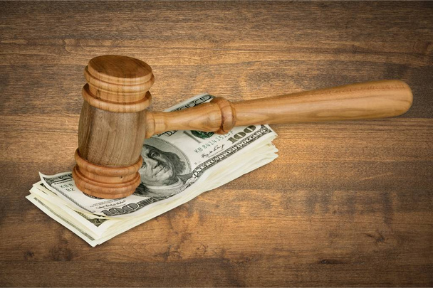 Wooden judge gavel and stack of dollar cash - Foto, immagini