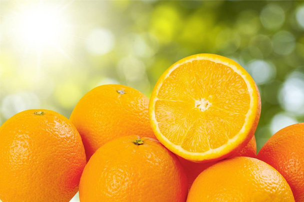 Ripe oranges on blurred natural background - Photo, Image