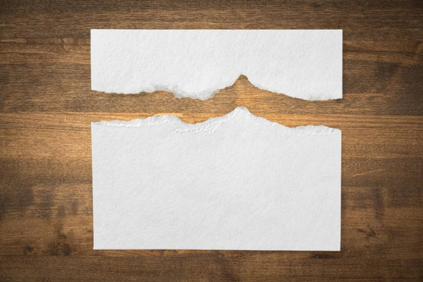 torn white blank paper on wooden planks background - Photo, Image