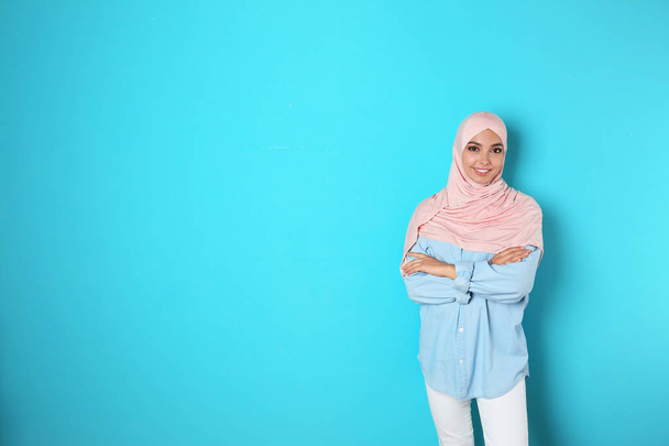 Portrait of young Muslim woman in hijab against color background. Space for text - Photo, Image