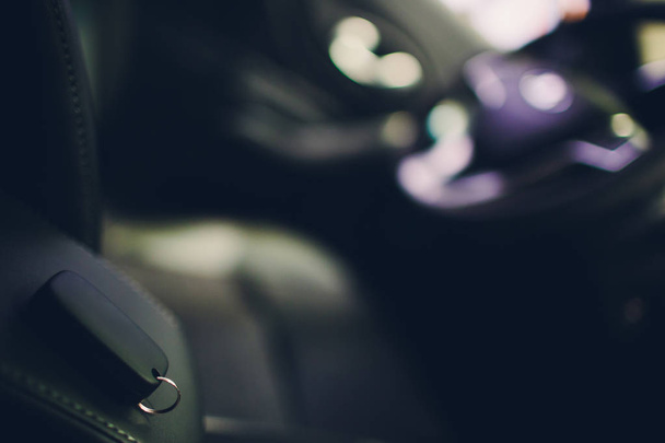 Closeup inside vehicle of wireless key ignition. Car key remote in black perforated leather interior. Car detailing. Keys close up. - Valokuva, kuva