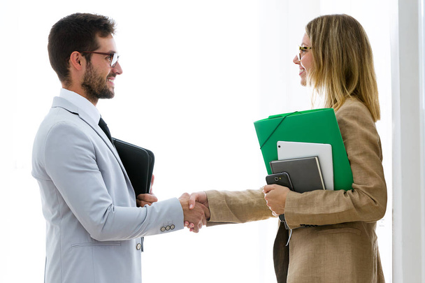 Shot of two attractive bussines partners shaking their hands in the office. - Photo, Image