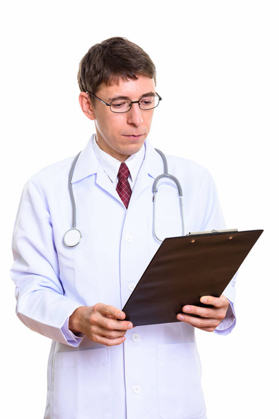Studioaufnahme eines Arztes beim Lesen auf Klemmbrett - Foto, Bild