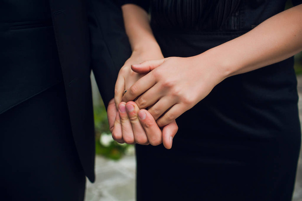 Close-up image of a young couple holding hands. - Фото, зображення