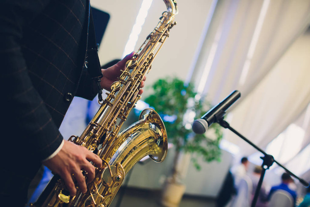 Musical instruments, Saxophone Player hands Saxophonist playing jazz music. Alto sax musical instrument closeup. - Фото, изображение