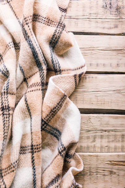 Plaid wool plaid on old wooden background - Photo, Image
