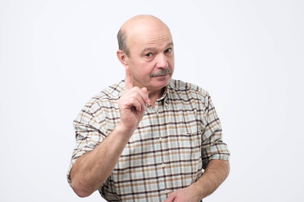 Strict senior man showing index fingers up, giving advice - Photo, Image