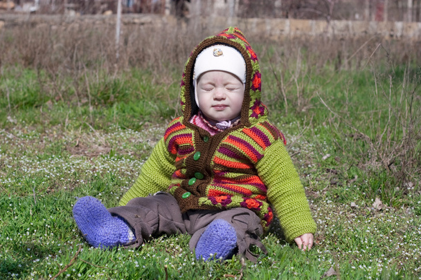 child in bright clothes in the sun blinks - Photo, Image