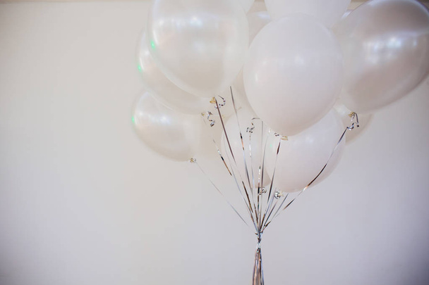 a bunch of transparent balloons close up with golden dust within on a gray blurry background. - Fotografie, Obrázek