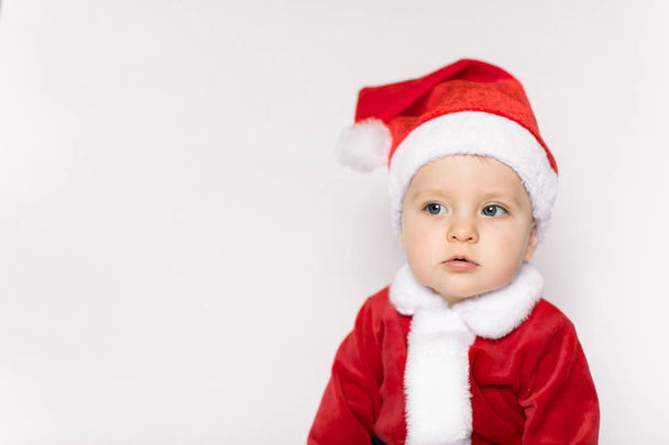 Christmas toddler in Santa hat on white background - Foto, afbeelding