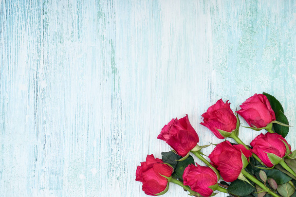 Bouquet of pink roses on blue background. Top view, copy space. Greeting card, holiday concept - Φωτογραφία, εικόνα