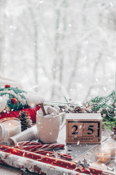 25 December Calendar. Christmas decor: Warm sweater, cup of hot cocoa with marshmallow, candy, candles and Christmas tree. Winter mood, holiday decoration. - Photo, Image