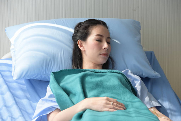 Aisan woman sleeping on bed in hospital - Fotoğraf, Görsel