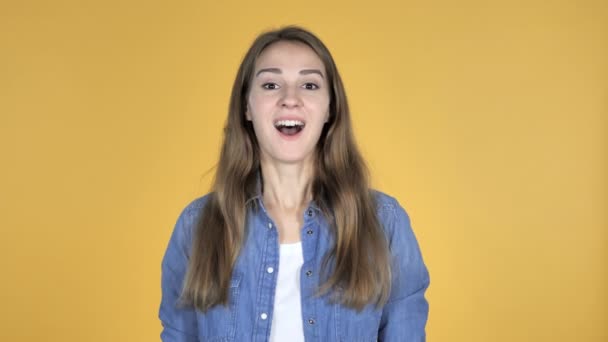 Pretty Woman Gesturing Thumbs Up Isolated on Yellow Background - Záběry, video