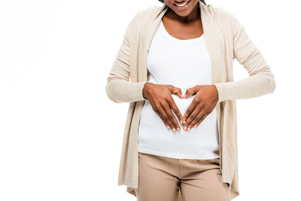 těhotná žena afroamerické usmívá a dotýká břicho izolované na bílém - Fotografie, Obrázek