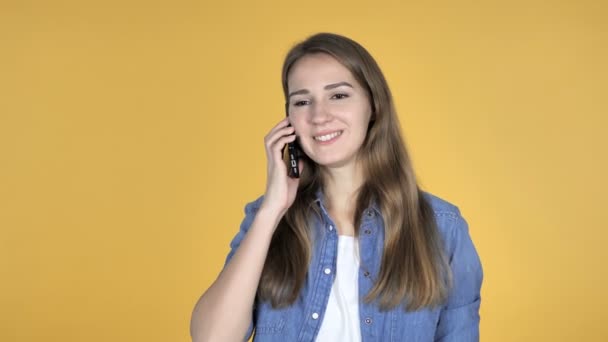 Pretty Woman Talking on Smartphone Isolated on Yellow Background - Video