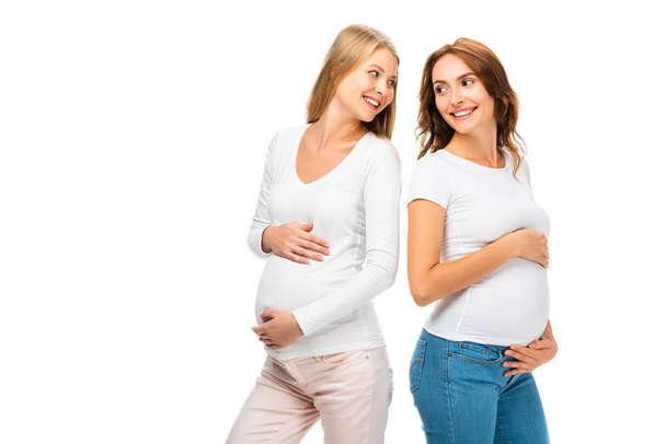 hermosas mujeres embarazadas mirándose aisladas en blanco
 - Foto, Imagen