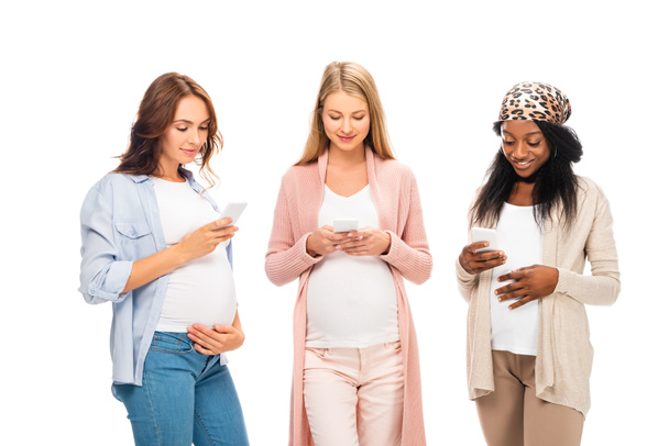 beautiful multicultural pregnant women using smartphones isolated on white - Foto, Bild