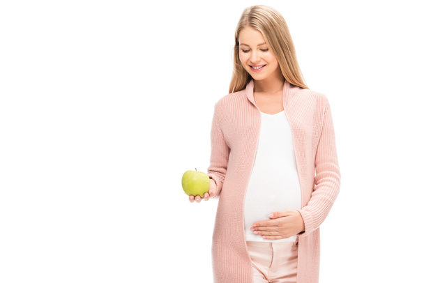 beautiful pregnant woman holding green apple and smiling isolated on white - Foto, imagen