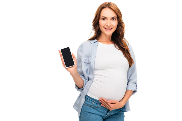 白で隔離のスマート フォンを保持している妊娠中の女性 - 写真・画像