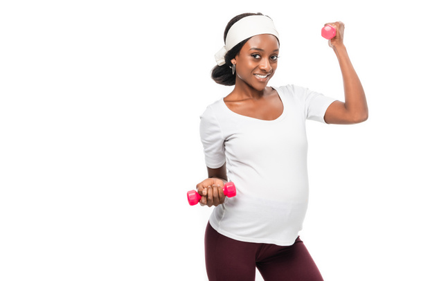 african american pregnant woman holding dumbbells in hands isolated on white - Fotó, kép