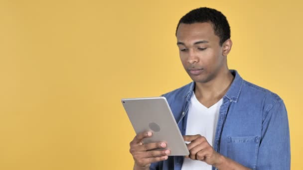 Young African Man Browsing Internet, Using Tablet - Felvétel, videó