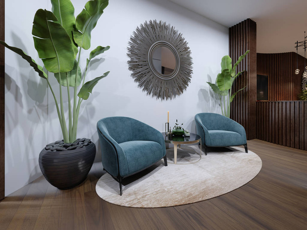 El área de descanso de hotes cuenta con dos sillones de diseño en azul con una planta en maceta y un zeokal en una pared blanca
.  - Foto, imagen