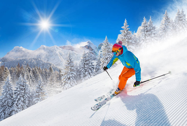Skier skiing downhill in high mountains - Fotoğraf, Görsel