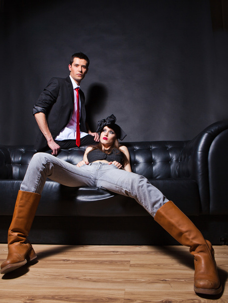 Handsome fashion couple sitting on sofa - Fotoğraf, Görsel