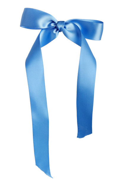 Satin cloth tied as a bow to make a birthday gift ribbon used for presents or wedding decoration.  The design is isolated on a white background. - Photo, Image