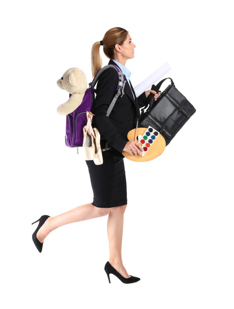 Businesswoman with lots of things running on white background. Combining life and work - 写真・画像