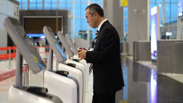 Homem de negócios no aeroporto check-in bilhete no quiosque terminal
 - Filmagem, Vídeo
