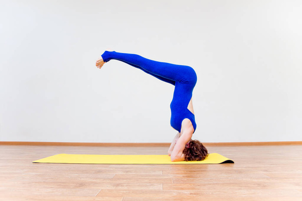 a woman practicing yoga exercises at home - Valokuva, kuva