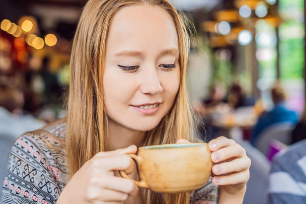 Young woman drinking homemade Indian sweet masala tea with spices. - Zdjęcie, obraz
