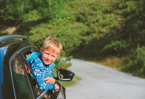 happy little boy enjoy travel by car in nature - Foto, imagen